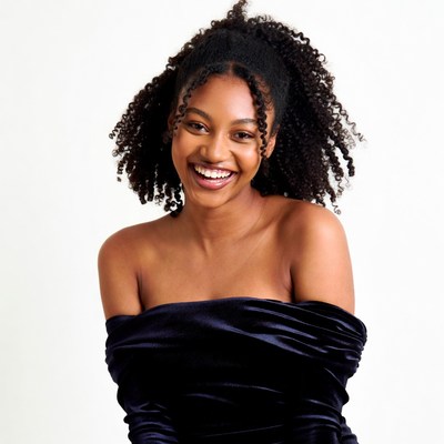 Smiling African-American woman in off-shoulder dress