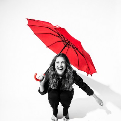 Smiling woman holding red umbrella