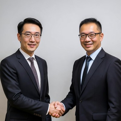 Two Asian men shaking hands in suits