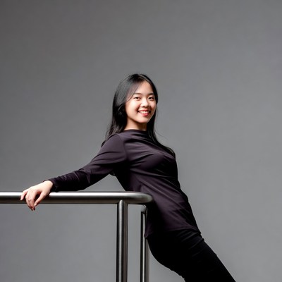 Asian woman leaning on railing