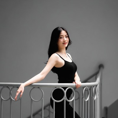 Asian woman leaning on staircase railing