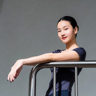 Asian woman leaning on railing