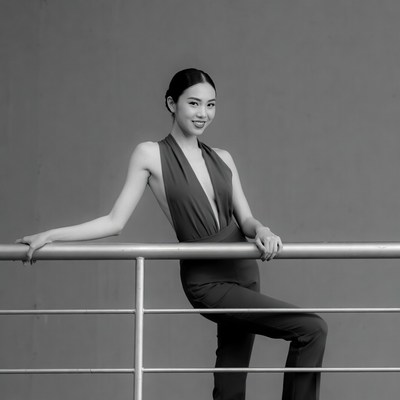Asian woman leaning on railing
