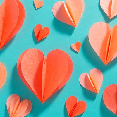 Orange paper hearts on blue background