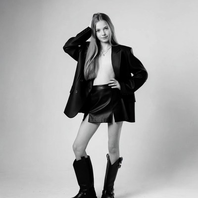 Teen girl in blazer skirt boots