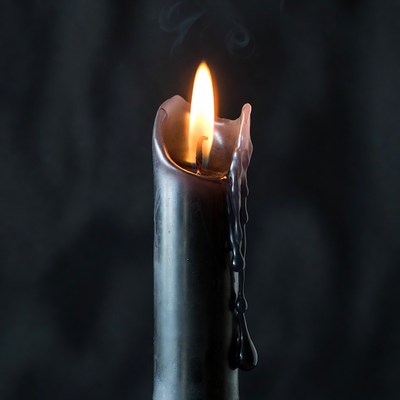 Burning Black Candle with Dripping Wax