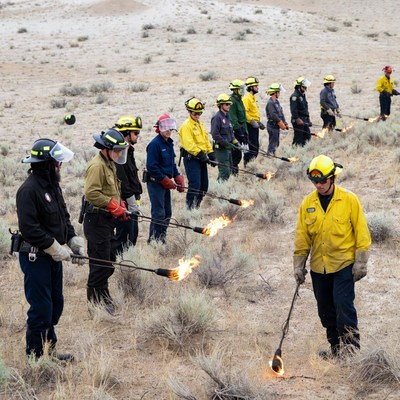 Firefighters holding flaming torches training