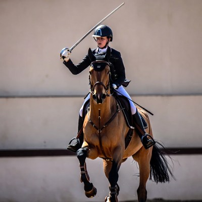 Woman epeÃ© fencing on horse