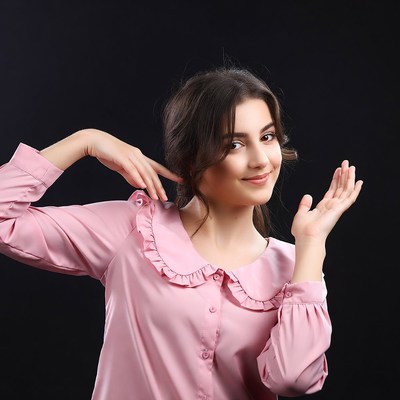 Smiling woman gesturing hands on black background