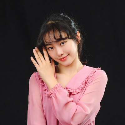 Asian woman making heart gesture