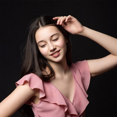 Young woman in pink dress posing
