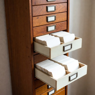 Wooden filing cabinet with open drawers