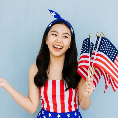 Asian girl holding American flags