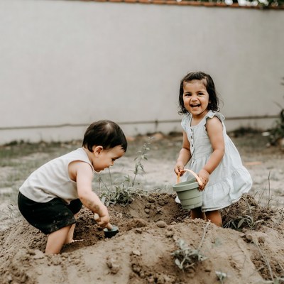 Toddlers planting with bucket and shovel