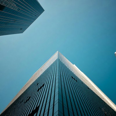 Tall glass skyscrapers against blue sky