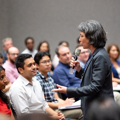 Woman speaking with microphone at conference