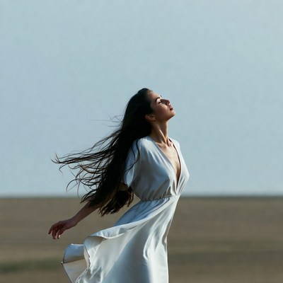 Woman in white dress gazing skyward