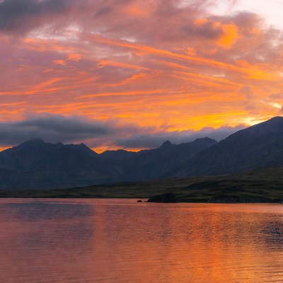 Sunset over mountains and lake