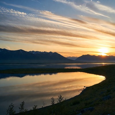 Sunset over mountains and lake