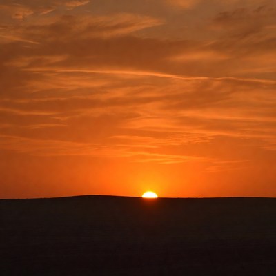 Sunset over silhouette hill
