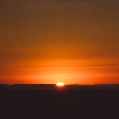 Sunset over silhouetted hills