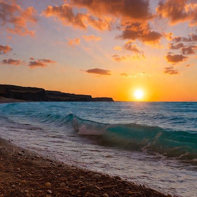 Sunset over beach with cliffs