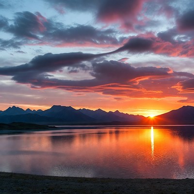 Sunset over mountains and lake