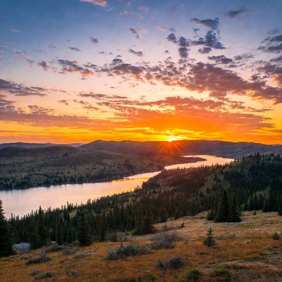 Sunset over river and mountains