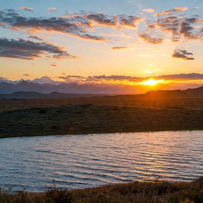 Sunset over mountains and lake
