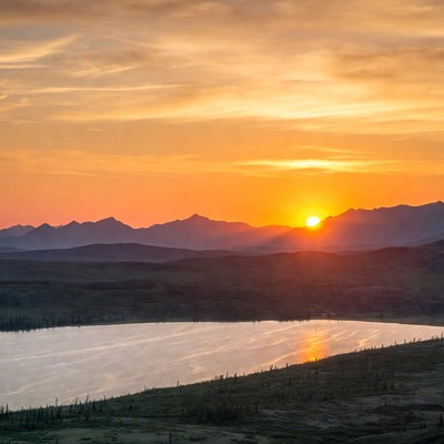 Sunset over mountains and lake