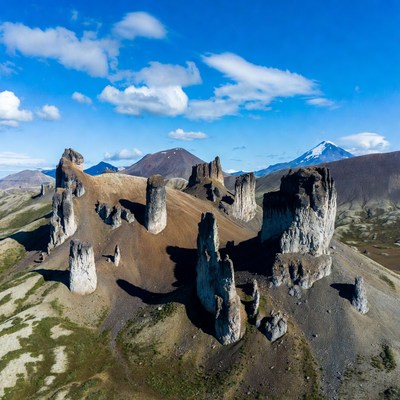 Rock Formations with Snowy Volcano