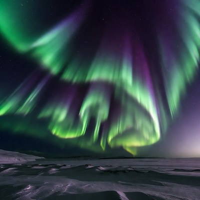 Vibrant Northern Lights over Snowy Landscape