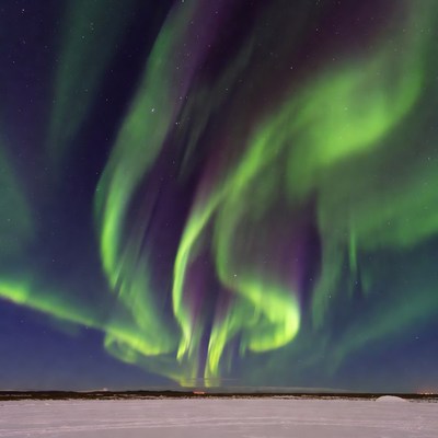 Vibrant Northern Lights over Snowy Landscape