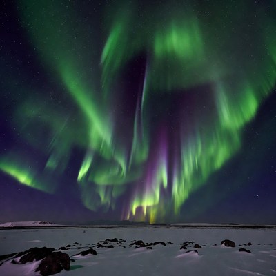 Vibrant Northern Lights over Snowy Landscape