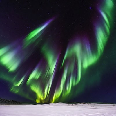 Vibrant Northern Lights over Snowy Landscape