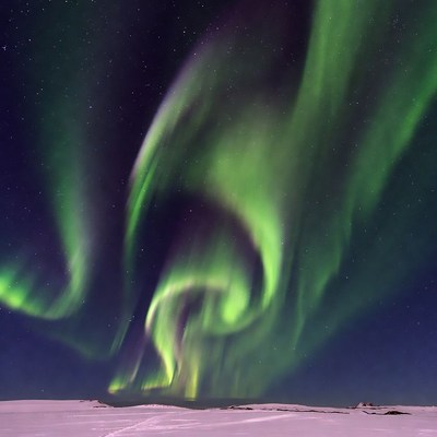 Vibrant Northern Lights over Snowy Landscape