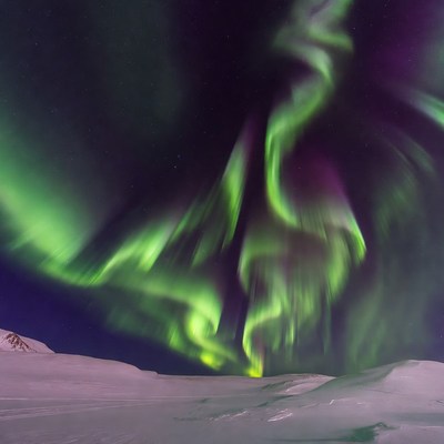 Vibrant Northern Lights over Snowy Landscape