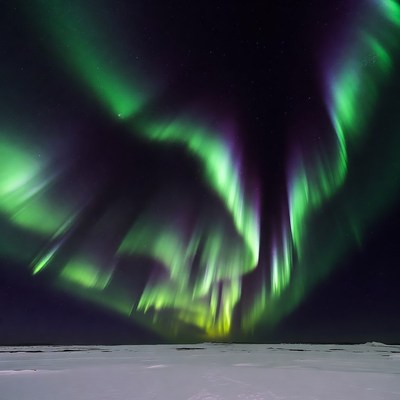 Vibrant Northern Lights over Snowy Landscape