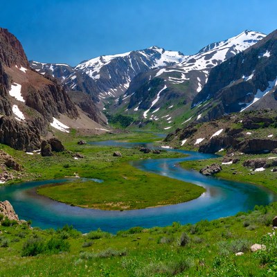 River meandering through snowy mountains