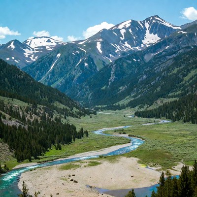 Snow-capped Mountains and Winding River Valley