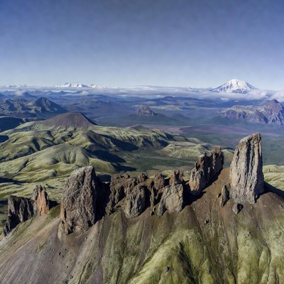 Rock Formations with Snowy Volcano Landscape