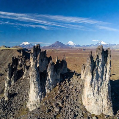 Stone Towers with Snowy Mountains