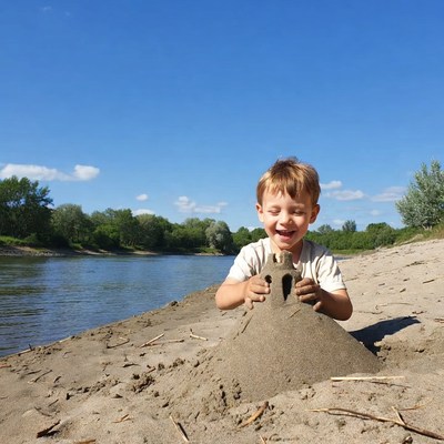 Boy building sandcastle on beach