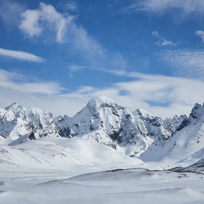 Snowy Mountain Peaks Under Blue Sky