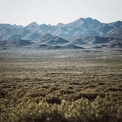 Layered Mountains Over Desert Plain