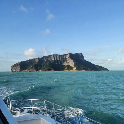 Island Cliff with Lush Vegetation from Boat
