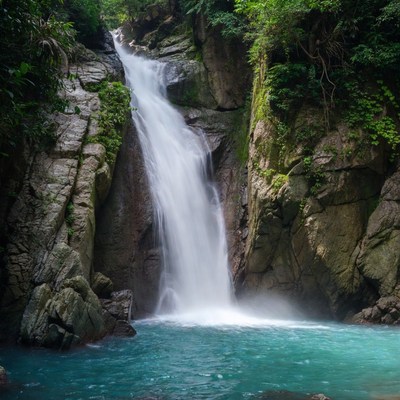 Tropical Waterfall Cascading into Turquoise Pool