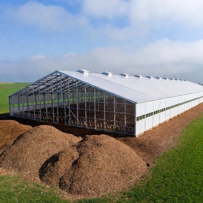Large White Greenhouse with Compost Piles