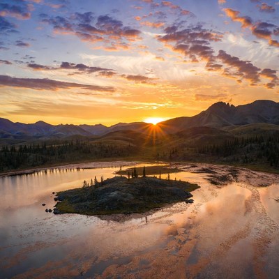 Sunset over mountain lake island