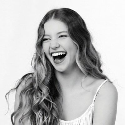 Young woman laughing with wavy hair